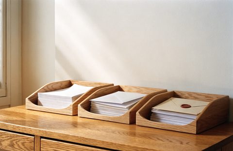 Letters sorted into three oak trays, a red wax seal on top.